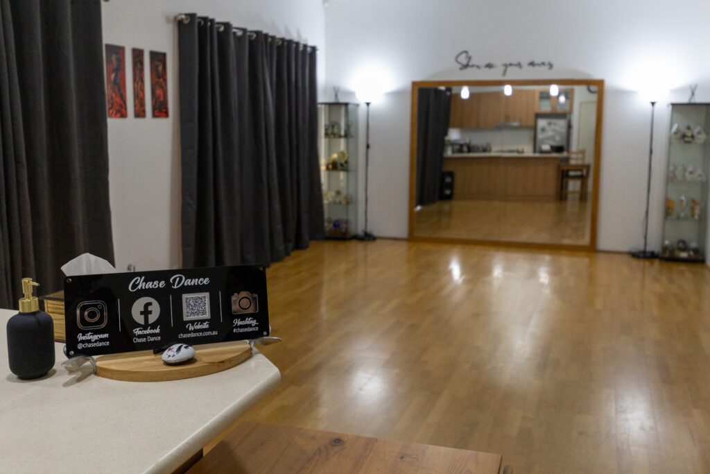 Chase Dance's dance studio space featuring mirrors, wooden floor and hand sanitiser. 